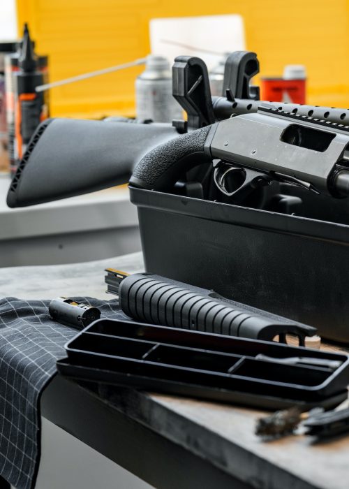 Automatic rifle on stand on the table of the weapons workshop.