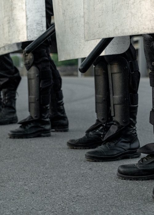 Legs of riot police at street